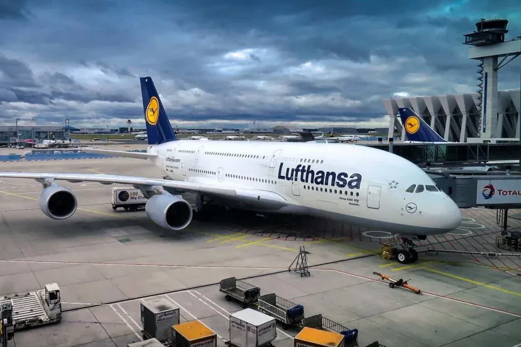 A plane waiting at a gate at an airport